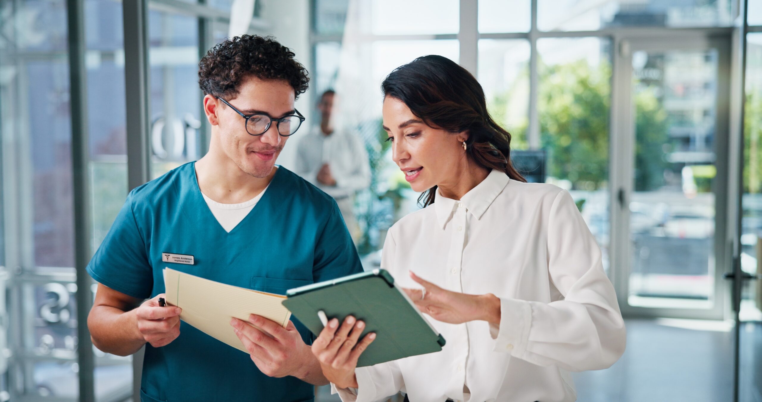 Two people in a healthcare setting talking to eachother